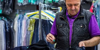 Older worker in dry cleaners