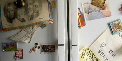 Family fridge covered in photos and magnets