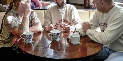 Three people talking around a table