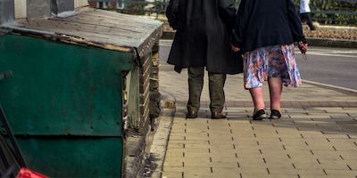 Couple walking down street, Nottingham