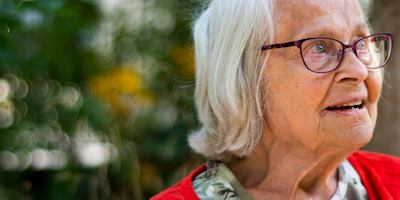 Older woman sitting on a park bench
