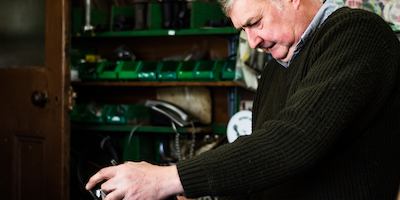 Older worker in a bike shop