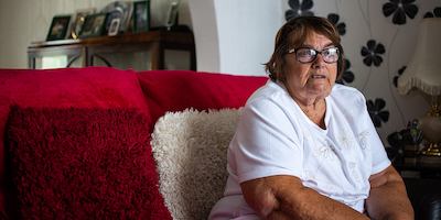 Older woman sitting on sofa