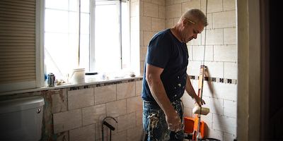 Worker making adaptations to a bathroom.