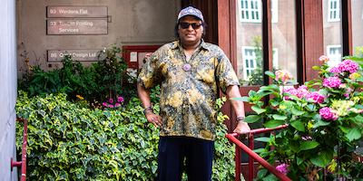 Older man standing outside in his community.