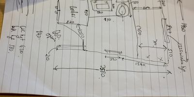 Hand drawn plans on a piece of paper.