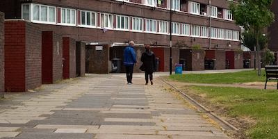 Man and woman walking on an estate.