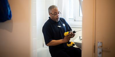 Handyman installing housing adaptation