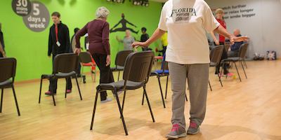 Elderly people doing a strength and balance class.