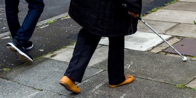 Person walking with walking stick
