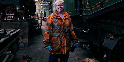 Older woman standing by railway