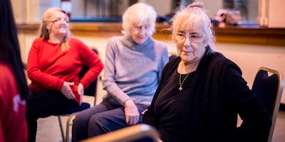 Valerie an older woman sitting on a chair