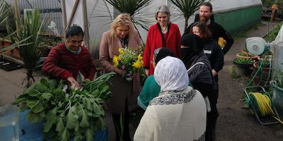 Anna Dixon, Mims Davis and a Sustain volunteer around a garden allotment