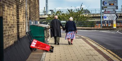 Older couple walking in street