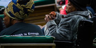 Two women sitting in chairs outside