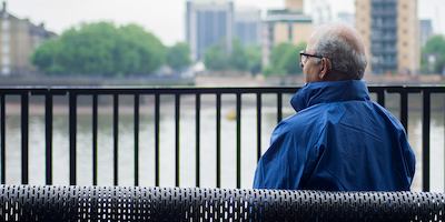 Older Asian man sitting on a bench