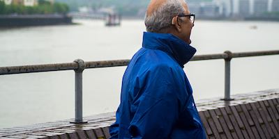 British Asian man looking onto the river
