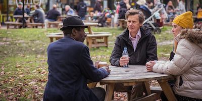 Group of people talking by a table