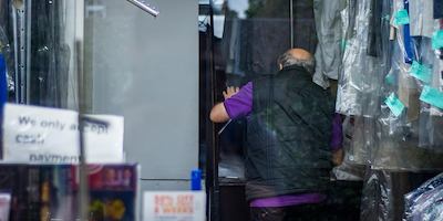 Older man in dry cleaner