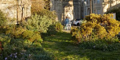 A pair of people walking by a church