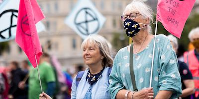 Older pair protesting with signs