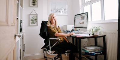 Older worker sitting by desk