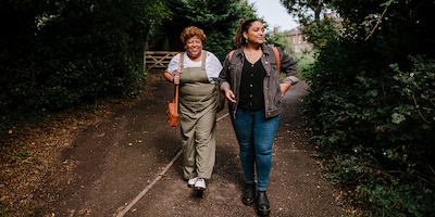 Older and younger people walking together