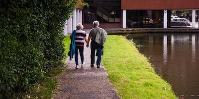 older couple walking outside