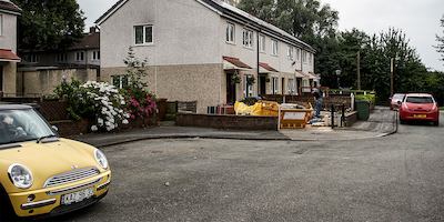 row of houses with cars outside
