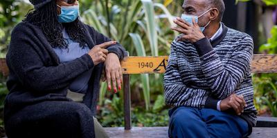 two older people talking outside