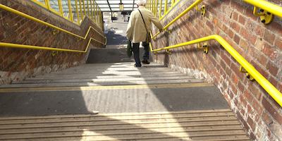 older man walking down stairs