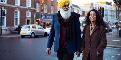 older man walking with younger woman
