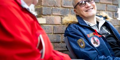 two men talking outside