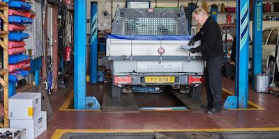 Older man working on car