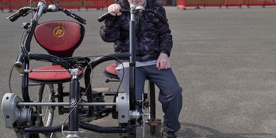 Dave sitting on a side by side bicycle