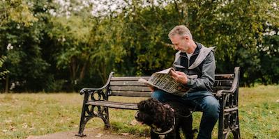 older man reading a newspaper