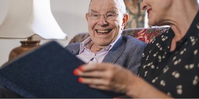 older man and woman reading together