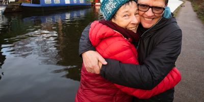 Jo and Liz hugging each other by a canal