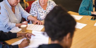 Group of older people sitting together and chatting