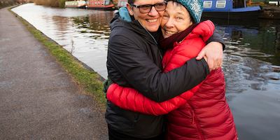An older couple hugging each other