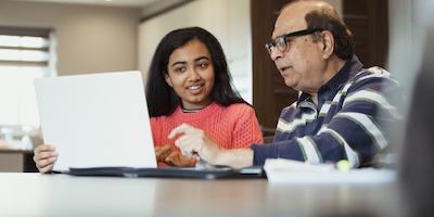 An older man and younger woman working together