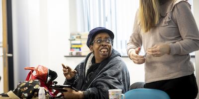 Two women chatting with an iPad in frame