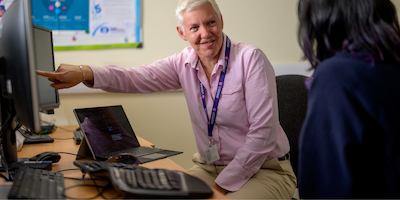 Two older women working from a desk