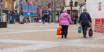 2 women walking down a street