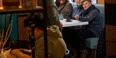 Group of older people chatting at a table