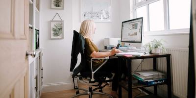Blonde woman working at computer