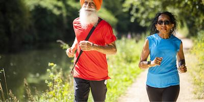Two older people running