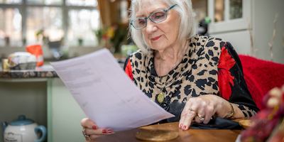 A woman reading a bill