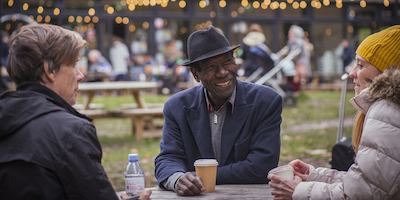 People sitting round the table having coffee and laughing