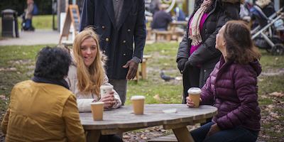 People sitting round the table having coffee and laughing